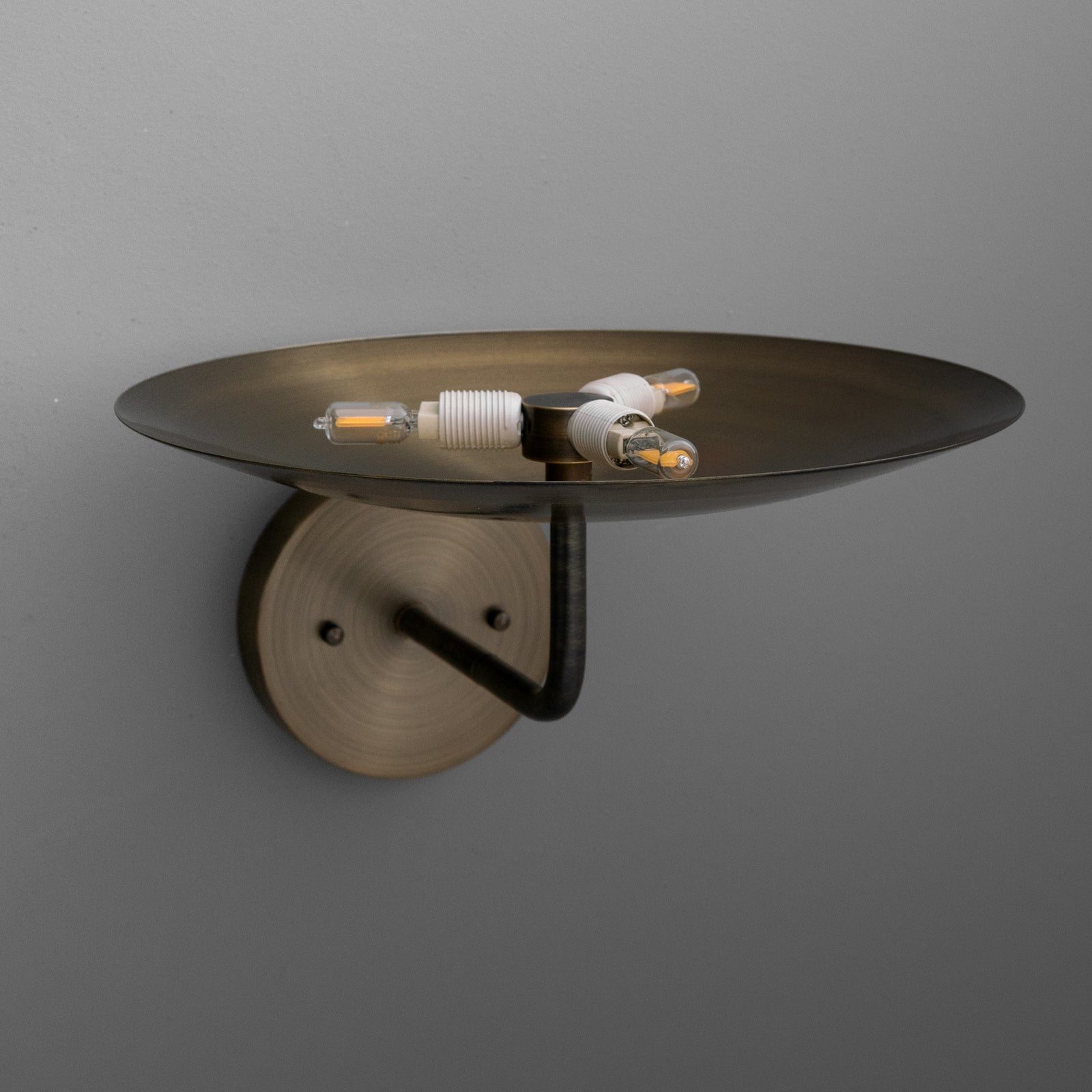 Wall sconce with a round, shallow bronze dish shade and exposed three LED filament bulbs mounted on a metal base. - SCONCE MODEL NO. 1504