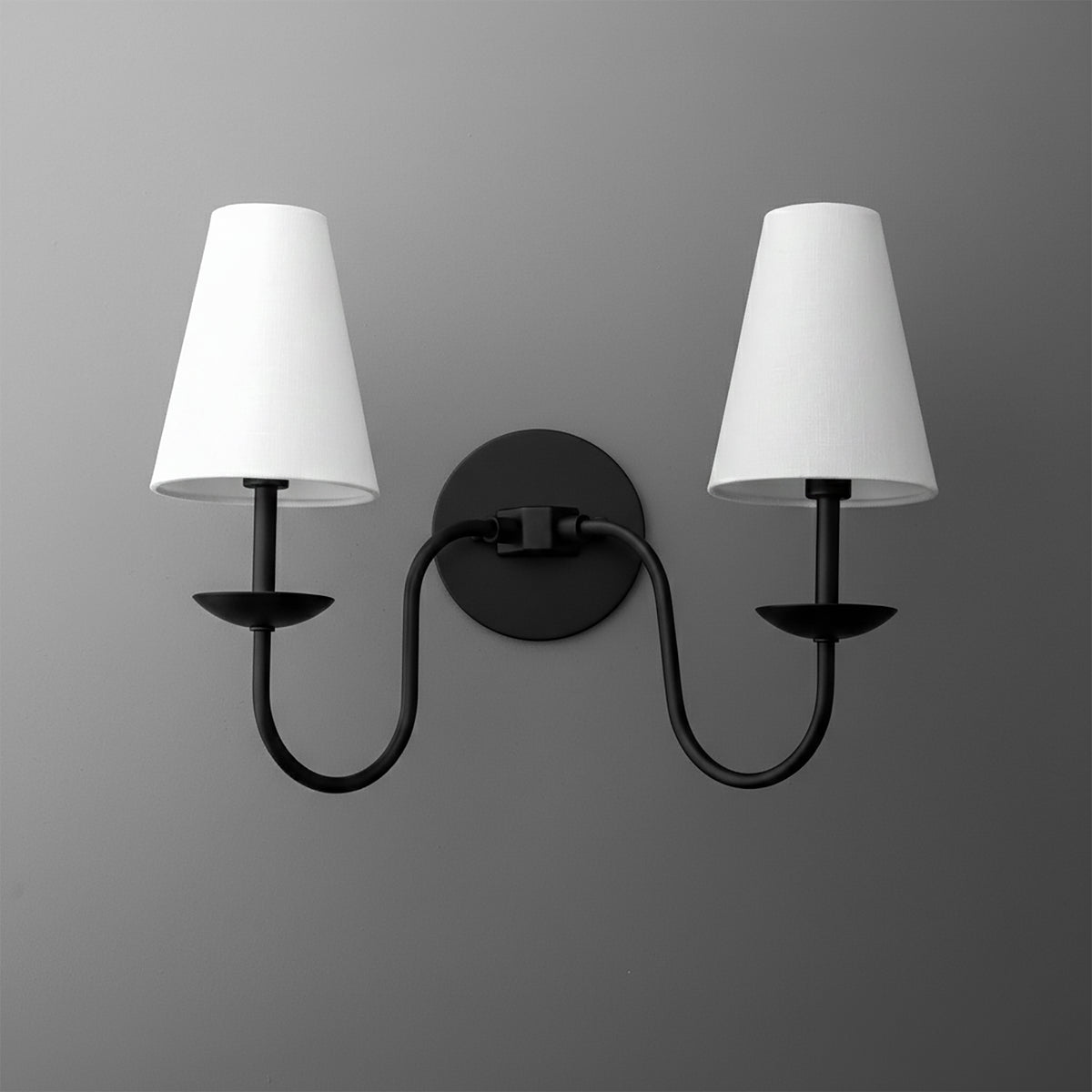 Black metal double-arm wall sconce with white tapered fabric shades and round mounting plate. - SCONCE MODEL NO. 5846