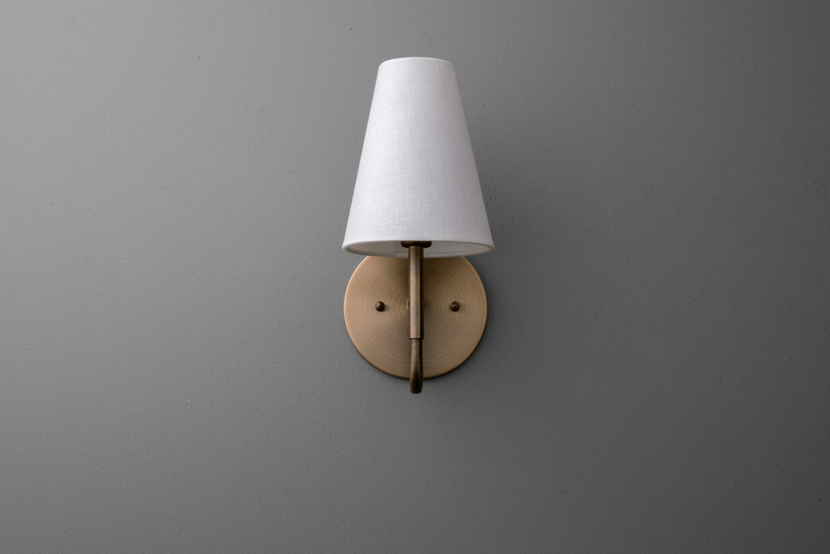 Wall sconce with antique brass finish and white fabric tapered lampshade. - SCONCE MODEL NO. 1699