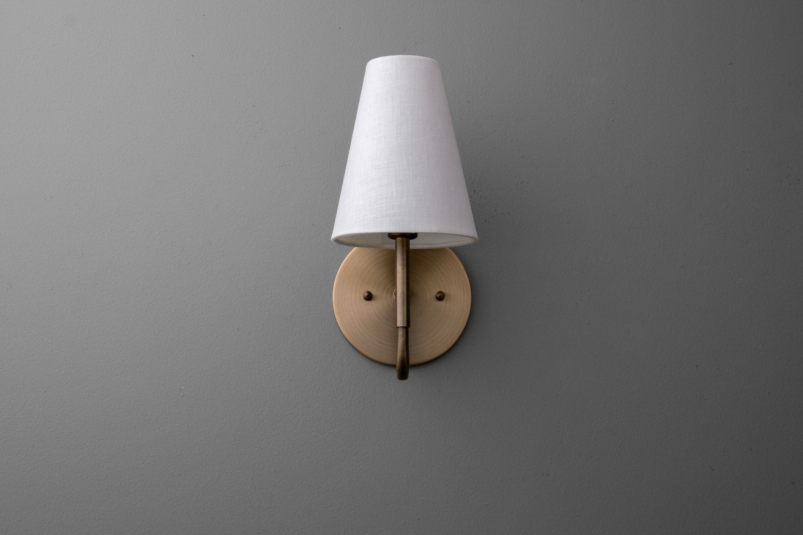 Wall sconce with antique brass finish and white fabric tapered lampshade. - SCONCE MODEL NO. 1699