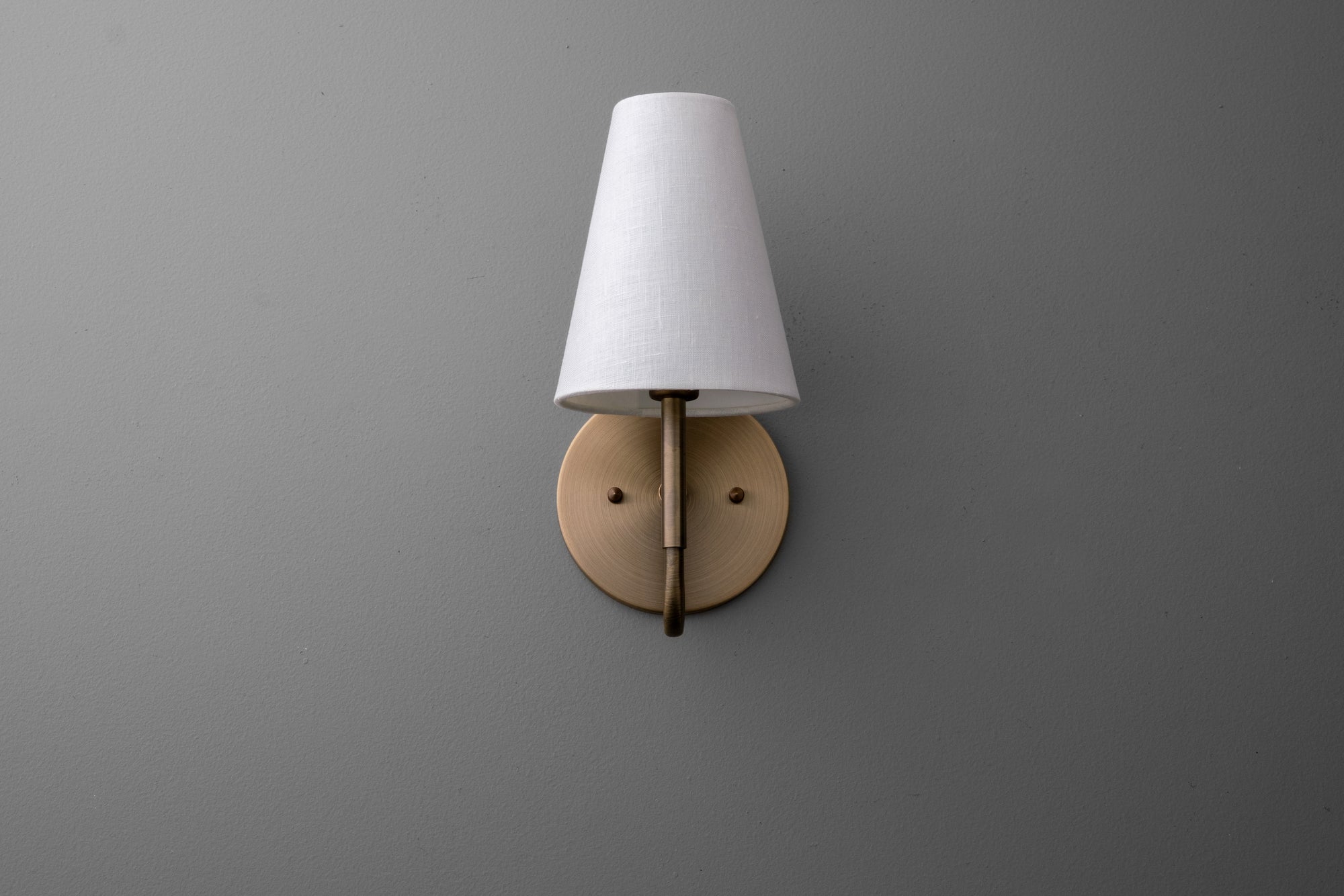 Wall sconce with antique brass finish and white fabric tapered lampshade. - SCONCE MODEL NO. 1699