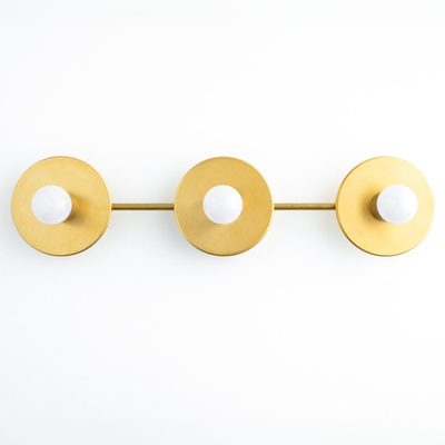 Mid-century modern vanity light with three round antique brass fixtures and exposed bulbs on a horizontal bar. - VANITY LIGHT MODEL NO. 5708