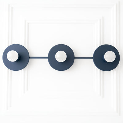 Black metal vanity light with three circular backplates and exposed round bulbs in mid-century modern style. - VANITY LIGHT MODEL NO. 5708