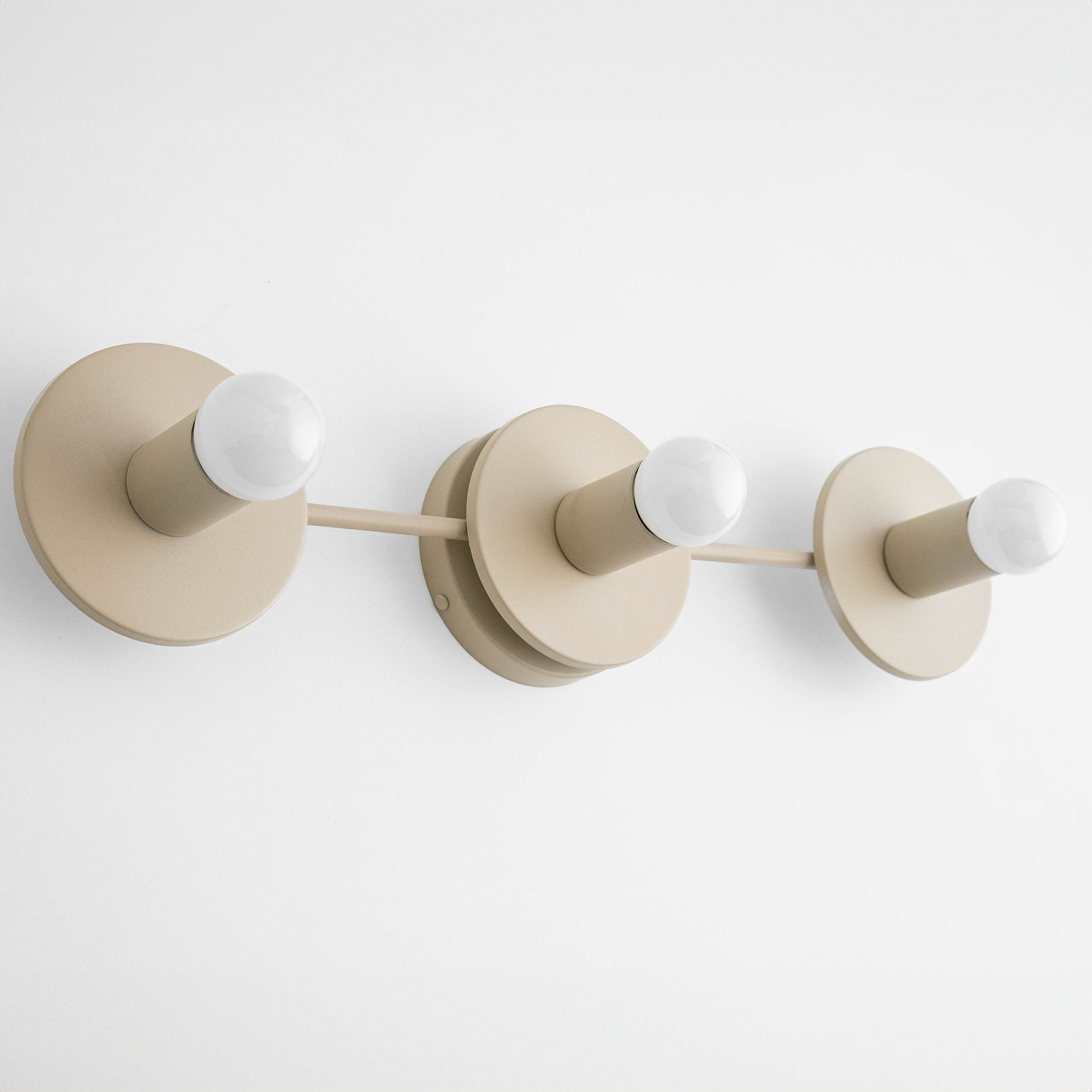 Matte cream three-bulb vanity light fixture with exposed round bulbs and circular backplates. - VANITY LIGHT MODEL NO. 5708