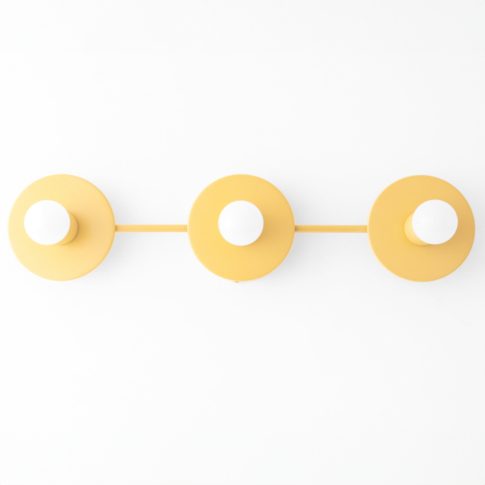 Three round mustard yellow metal vanity lights with exposed bulb sockets mounted in a horizontal row. - VANITY LIGHT MODEL NO. 5708