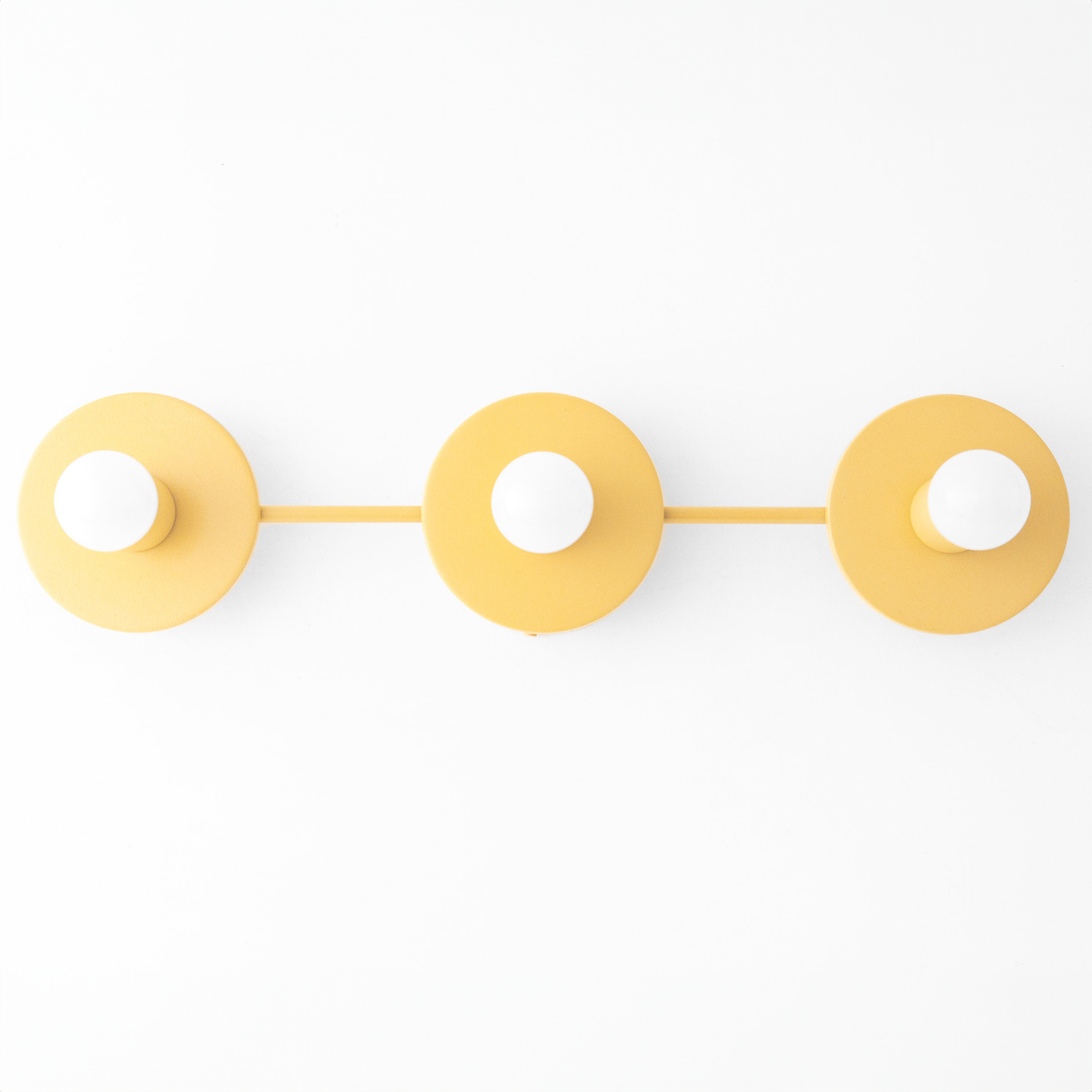 Three round mustard yellow metal vanity lights with exposed bulb sockets mounted in a horizontal row. - VANITY LIGHT MODEL NO. 5708