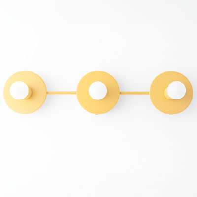 Three round mustard yellow metal vanity lights with exposed bulb sockets mounted in a horizontal row. - VANITY LIGHT MODEL NO. 5708