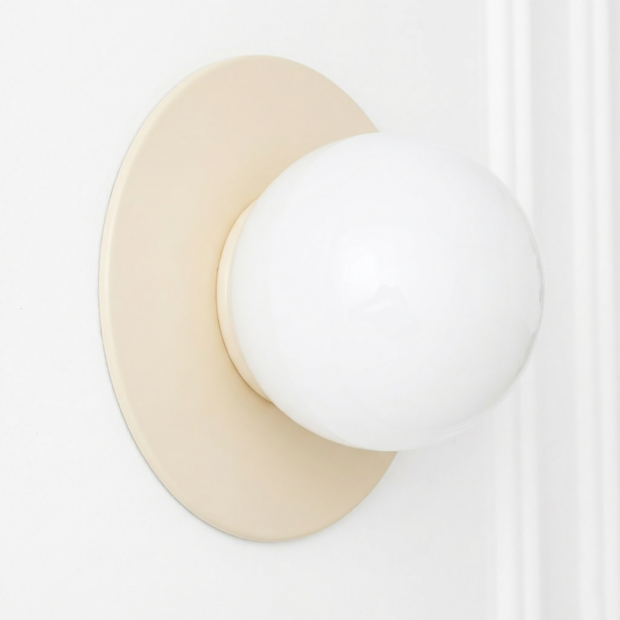 Scandinavian-style wall sconce with a round beige flush base and a white opaque glass globe bulb holder. - SCONCE MODEL NO. 2277