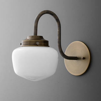 Vintage brass wall sconce with curved arm and frosted white glass shade. - SCONCE MODEL NO. 1012