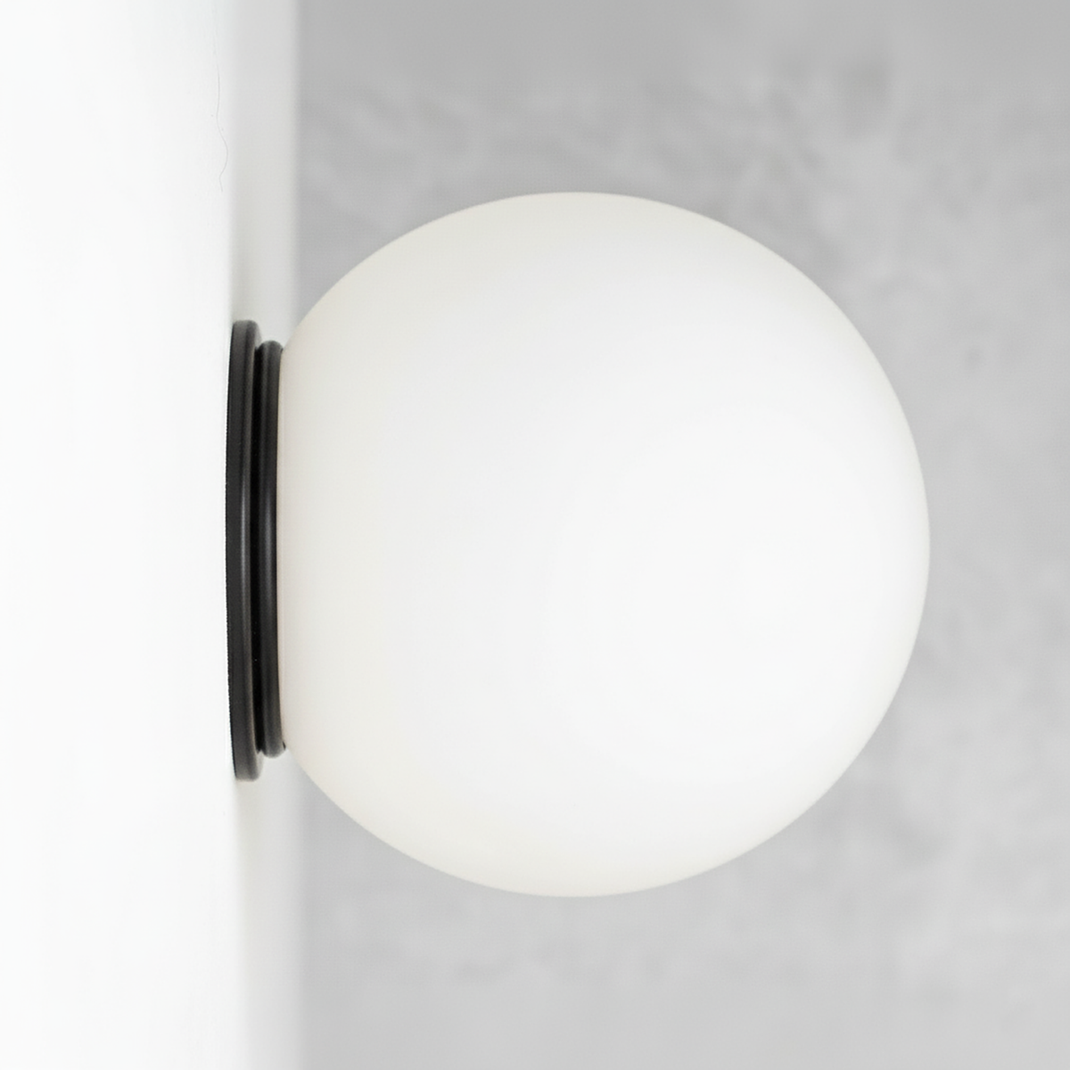 Mid-century modern black flush mount sconce with a white globe shade. - SCONCE MODEL NO. 4037