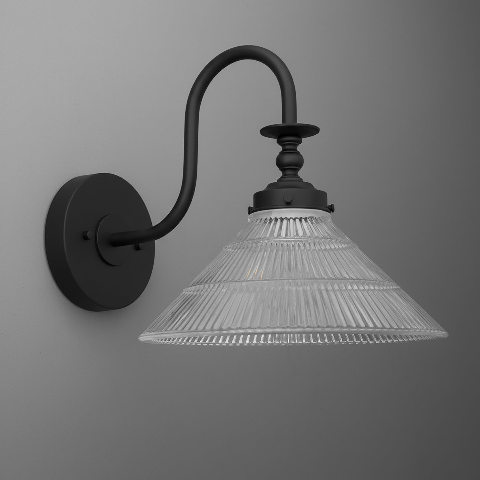 Black metal wall sconce with curved arm and clear ribbed glass conical shade. - SCONCE MODEL NO. 8036