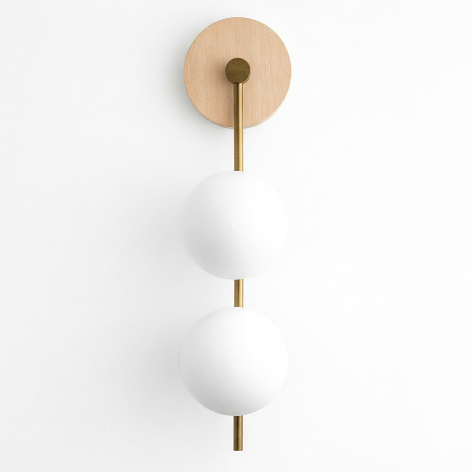 Wall sconce with natural wood round base and two stacked white glass globes on brass rod. - SCONCE MODEL NO. 0344