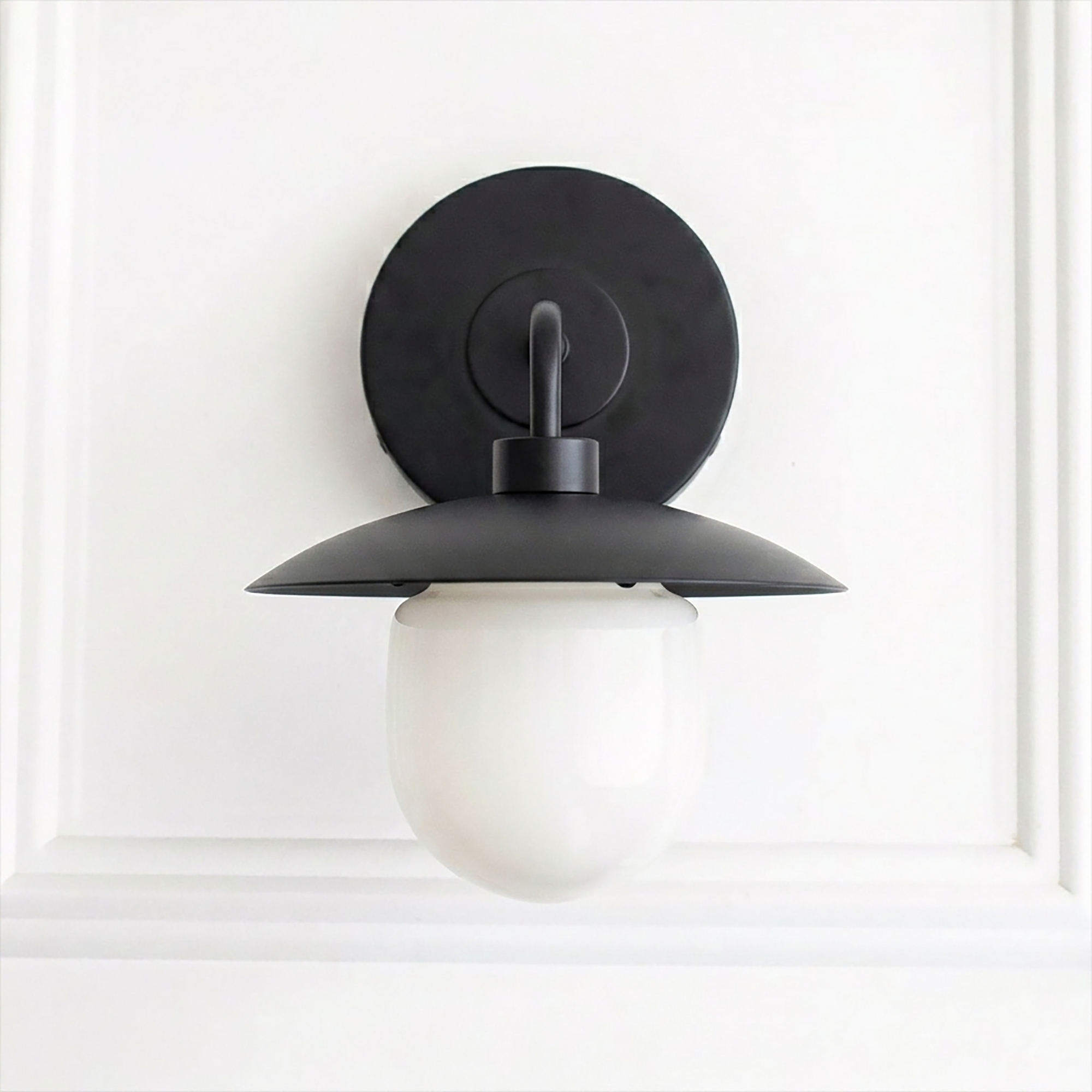 Matte black metal mid-century sconce with a white frosted globe shade and round backplate. - SCONCE MODEL NO. 7039