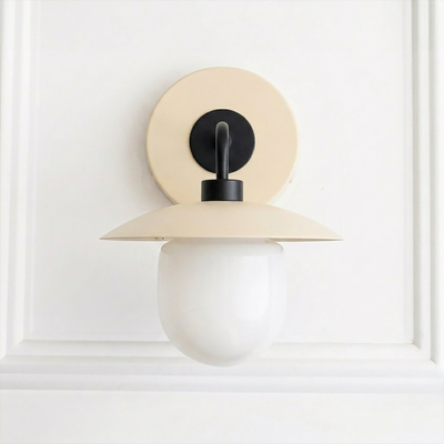 Mid-century modern cream metal sconce with round backplate and white globe bulb shade. - SCONCE MODEL NO. 7039