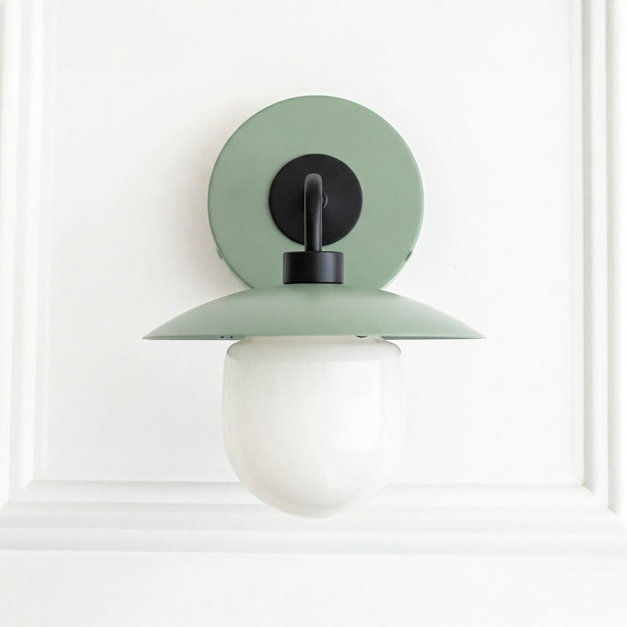 Mid-century modern green metal sconce with black fixture and white globe shade. - SCONCE MODEL NO. 7039