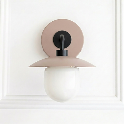 Mid-century modern sconce with matte pink circular backplate, black metal arm, and frosted white globe shade. - SCONCE MODEL NO. 7039