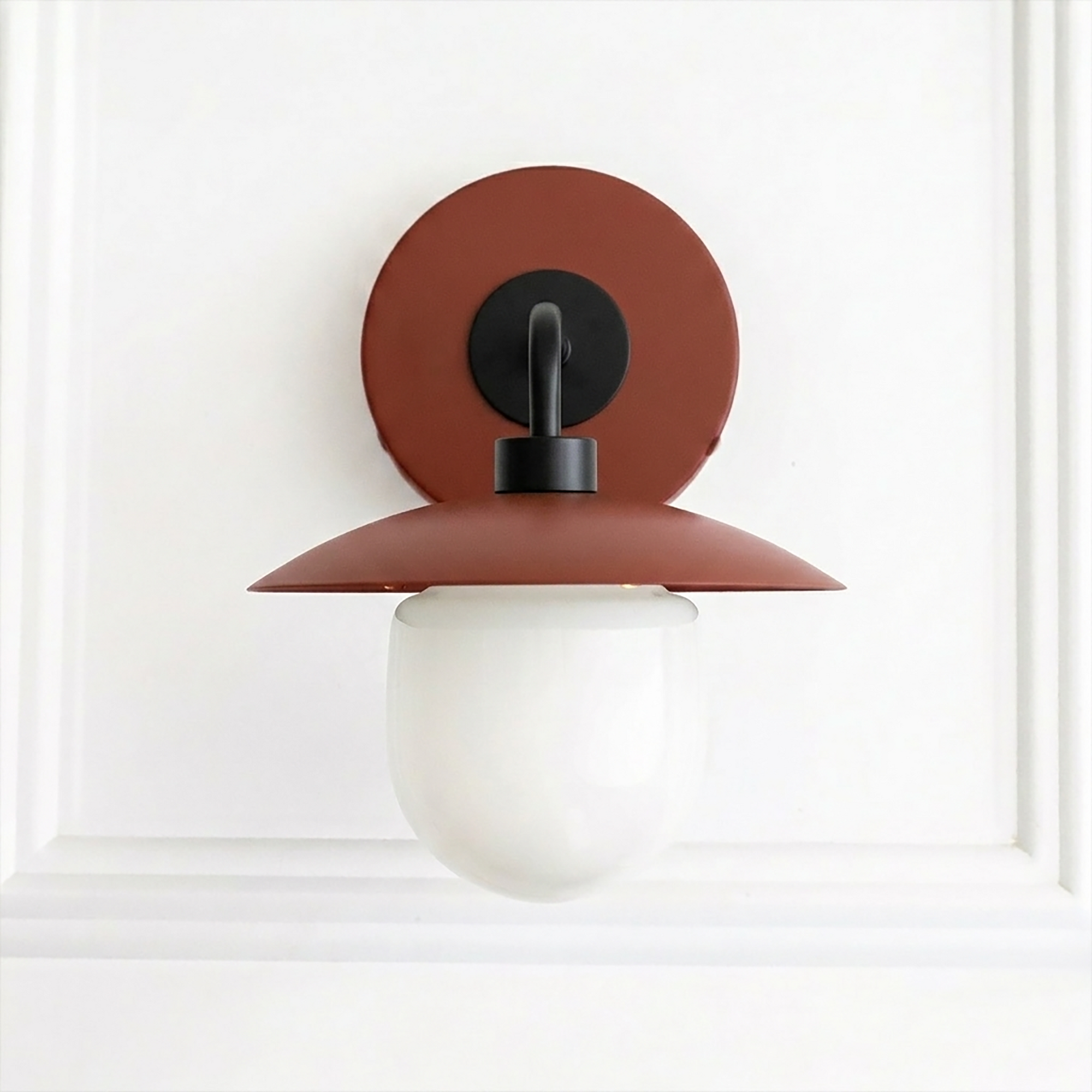 Mid-century modern wall sconce with matte rust metal shade and frosted white glass globe light. - SCONCE MODEL NO. 7039