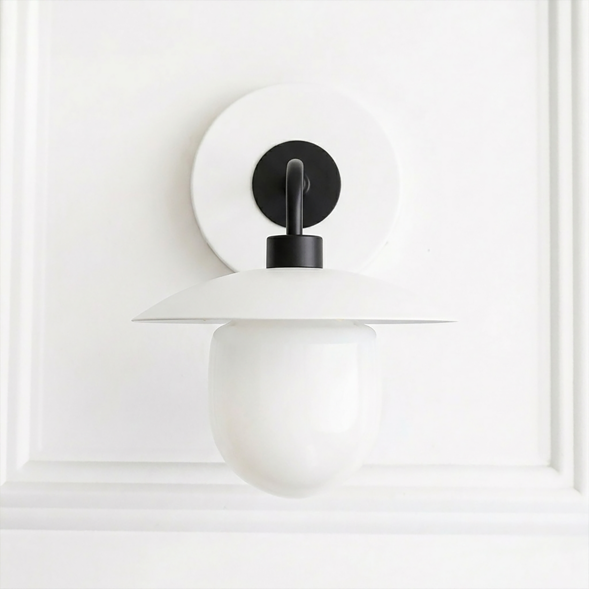 White and black mid-century modern semi-flush wall sconce with a rounded globe shade and flat disc top. - SCONCE MODEL NO. 7039