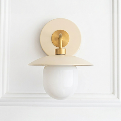 Mid-century modern cream and brass sconce with round backplate and frosted globe bulb shade. - SCONCE MODEL NO. 7039
