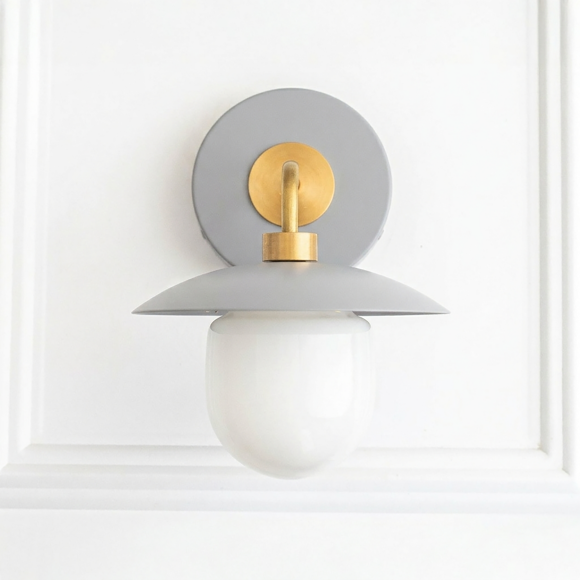 Mid-century modern wall sconce with gray metal shade, brass accents, and white globe bulb cover. - SCONCE MODEL NO. 7039