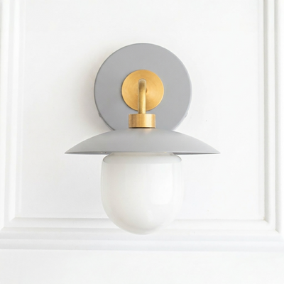 Mid-century modern wall sconce with gray metal shade, brass accents, and white globe bulb cover. - SCONCE MODEL NO. 7039
