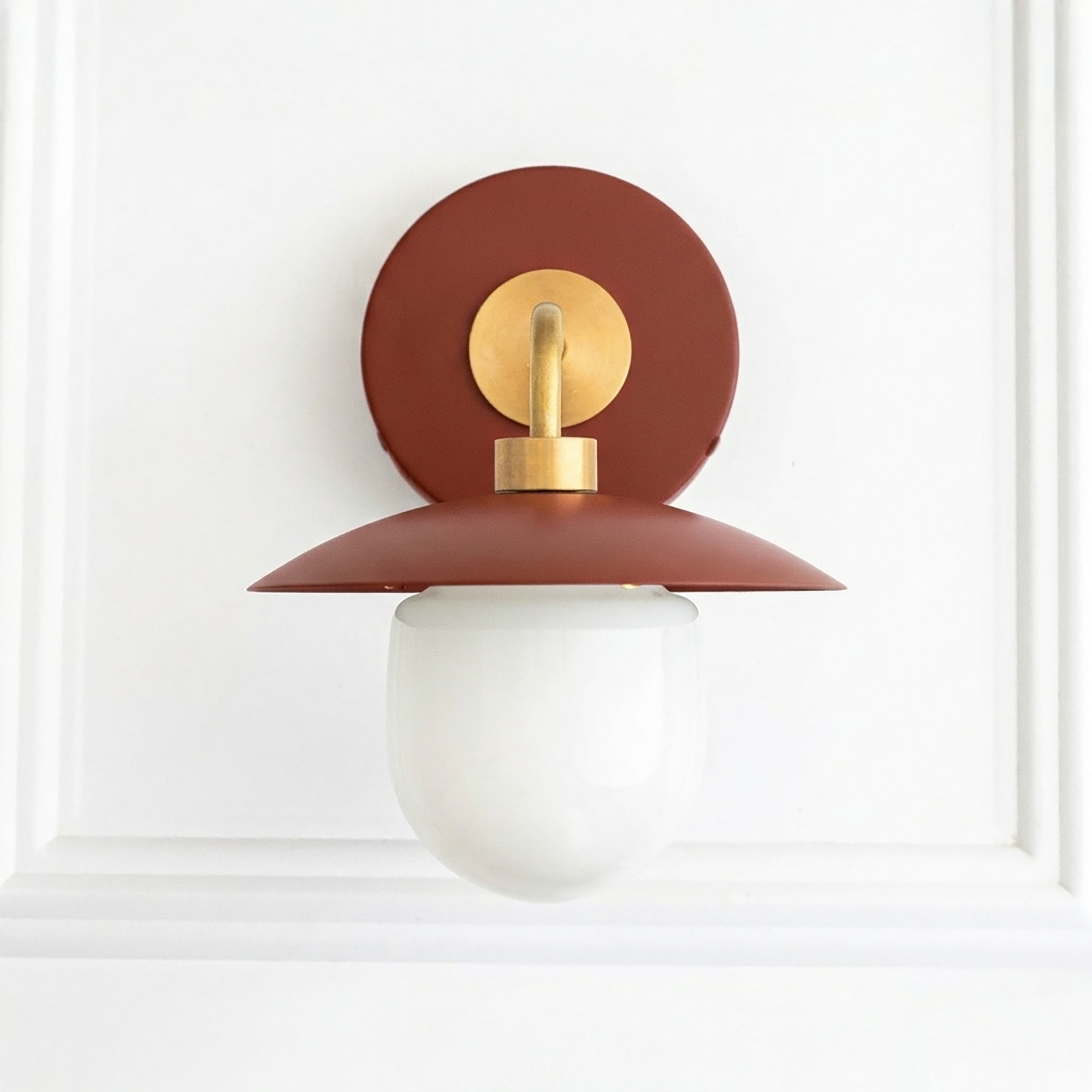 Mid-century modern wall sconce with rust-colored metal shade, brass accents, and white glass globe shade. - SCONCE MODEL NO. 7039