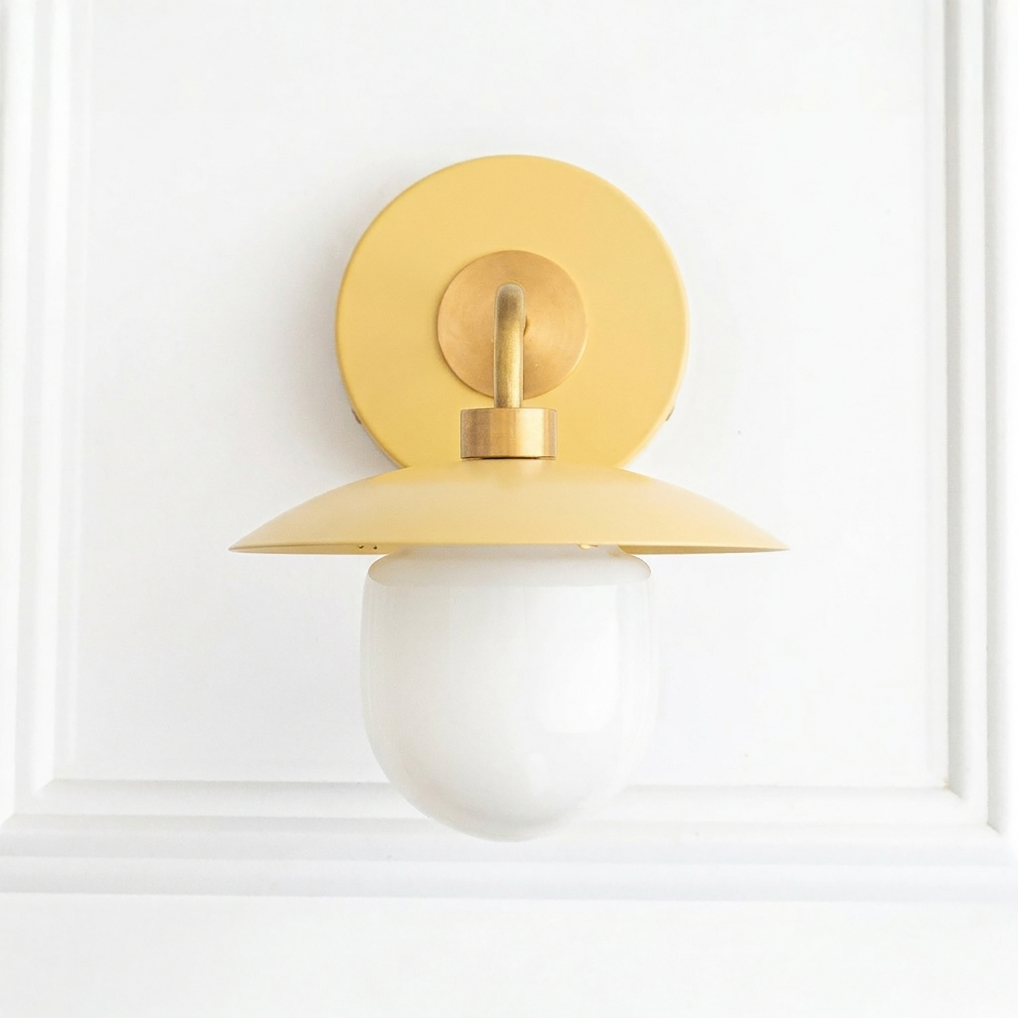 Yellow metal semi-flush sconce with round backplate and white globe shade in mid-century modern style. - SCONCE MODEL NO. 7039