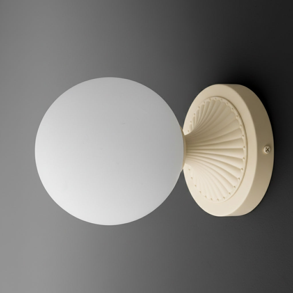 Round white glass globe sconce with cream ribbed circular base, minimalist modern design. - SCONCE MODEL NO. 5936