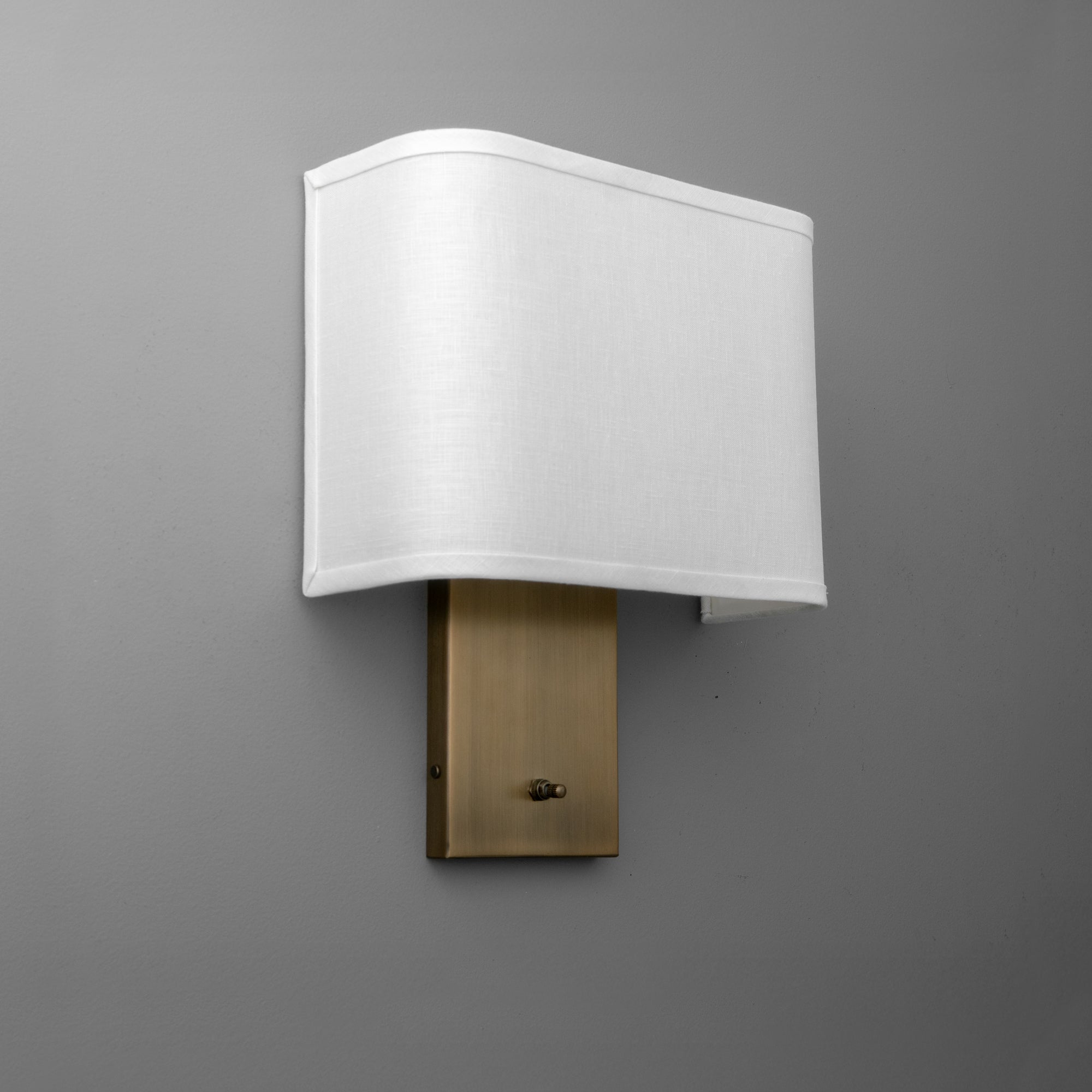 Wall sconce with rectangular white fabric shade and antique brass rectangular base. - SCONCE MODEL NO. 1918