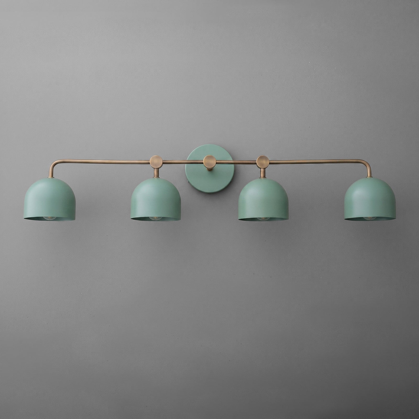 Four-light vanity light in Antique Brass with Green dome shades and a matching Green wall plate. - VANITY LIGHT MODEL NO. 1124