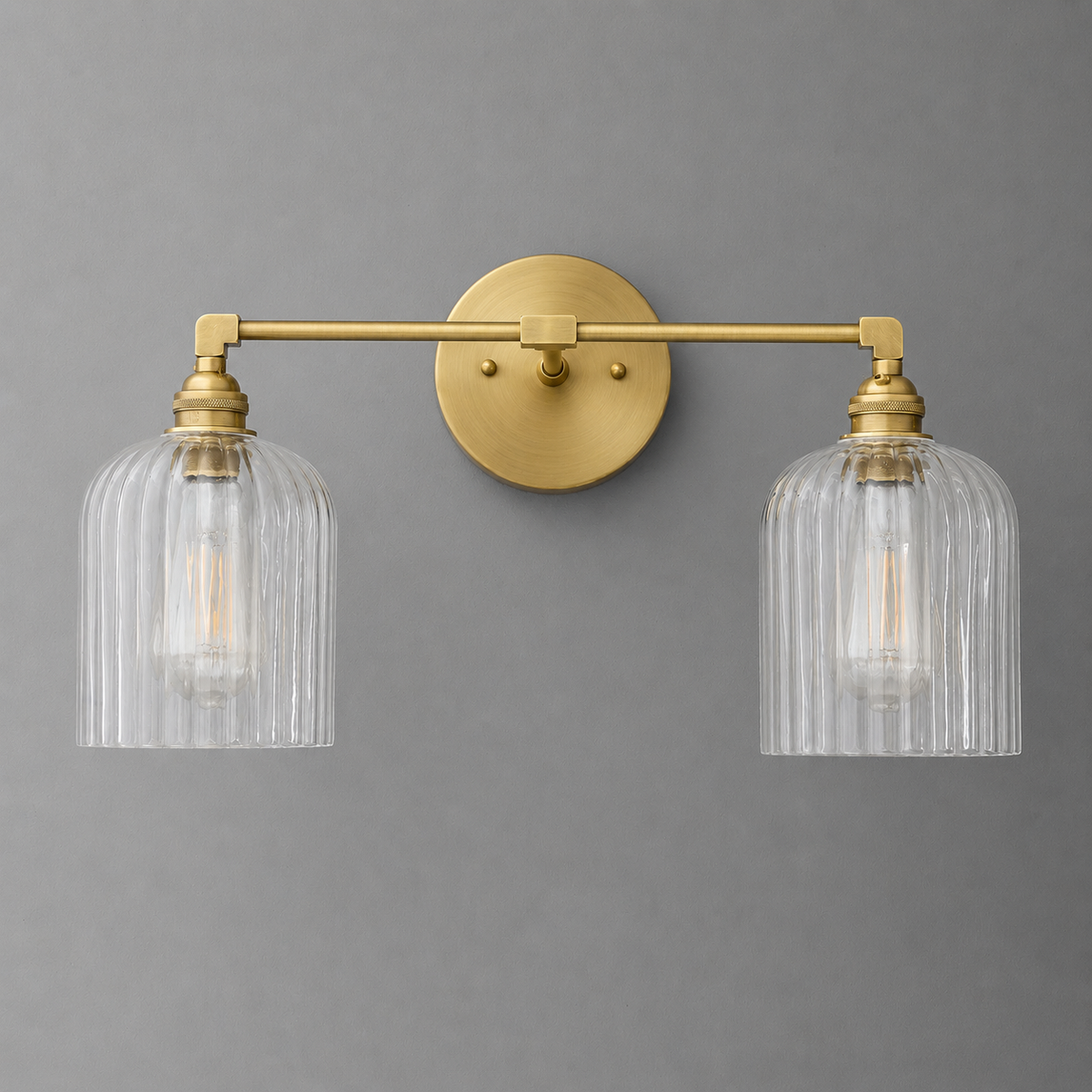 Two-bulb vanity light with brass finish and ribbed clear glass shades on a horizontal bar. - VANITY LIGHT MODEL NO. 1121