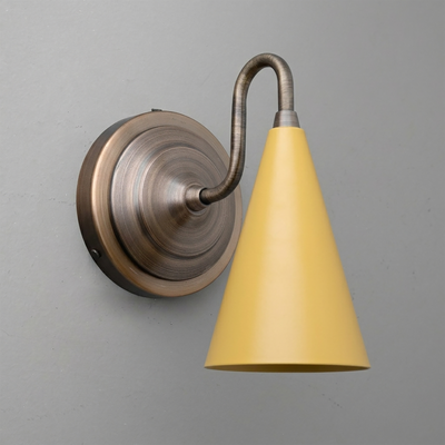 Brushed bronze round wall sconce with curved arm and yellow cone-shaped shade. - Sconce Model No. 6790
