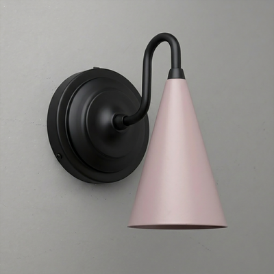 Black metal wall sconce with a curved arm and a pale pink conical shade pointing downward. - Sconce Model No. 6790