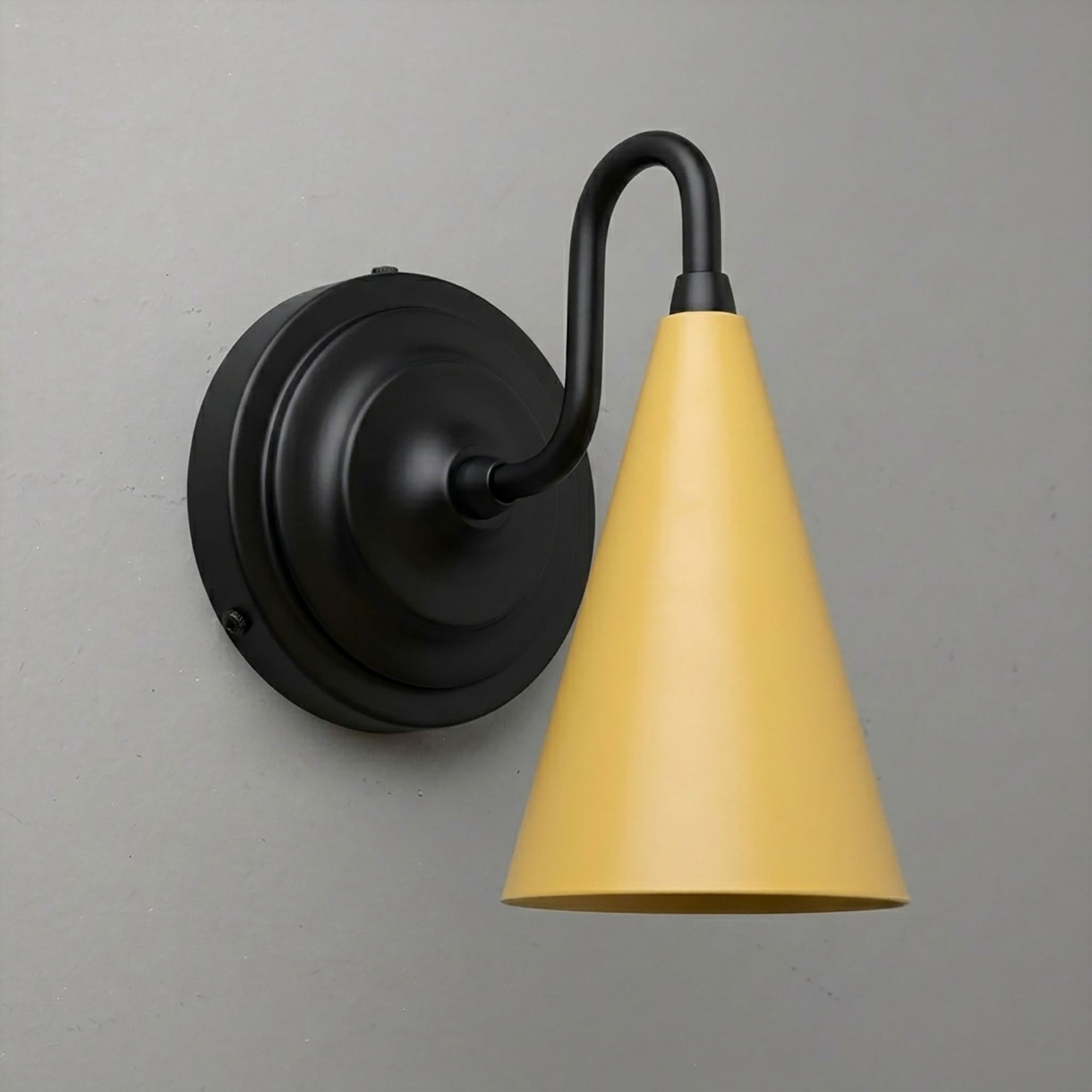 Matte black wall sconce with round base and yellow metal cone shade, up/down light design. - Sconce Model No. 6790