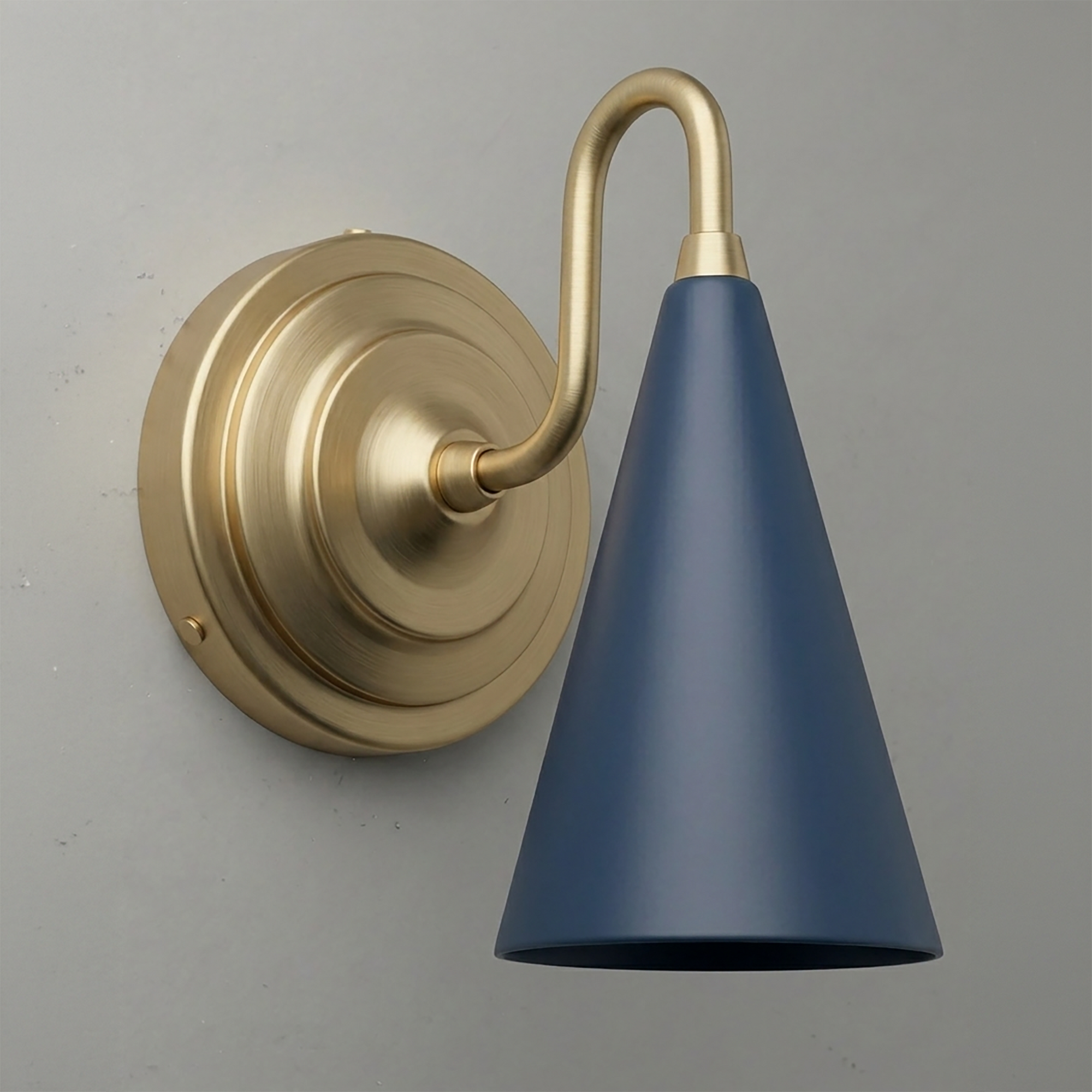 Brushed brass wall sconce with curved arm and matte navy blue conical shade. - Sconce Model No. 6790