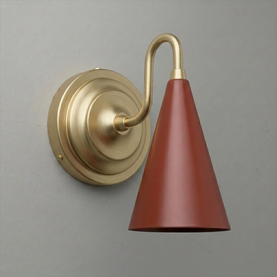 Brushed brass wall sconce with a curved arm and downward-facing matte terracotta cone shade. - Sconce Model No. 6790