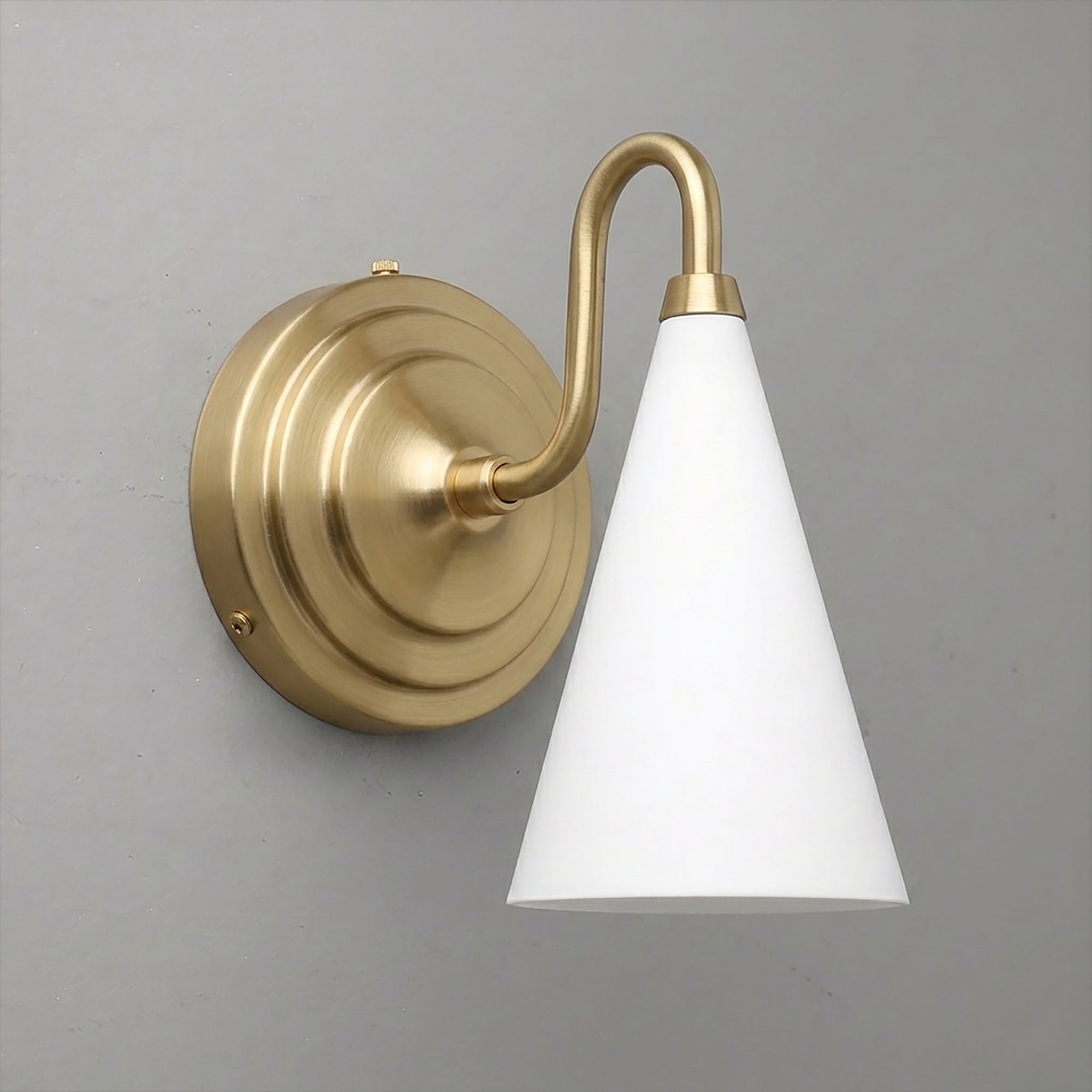 Brushed brass wall sconce with round base and white conical glass shade pointing downward. - Sconce Model No. 6790