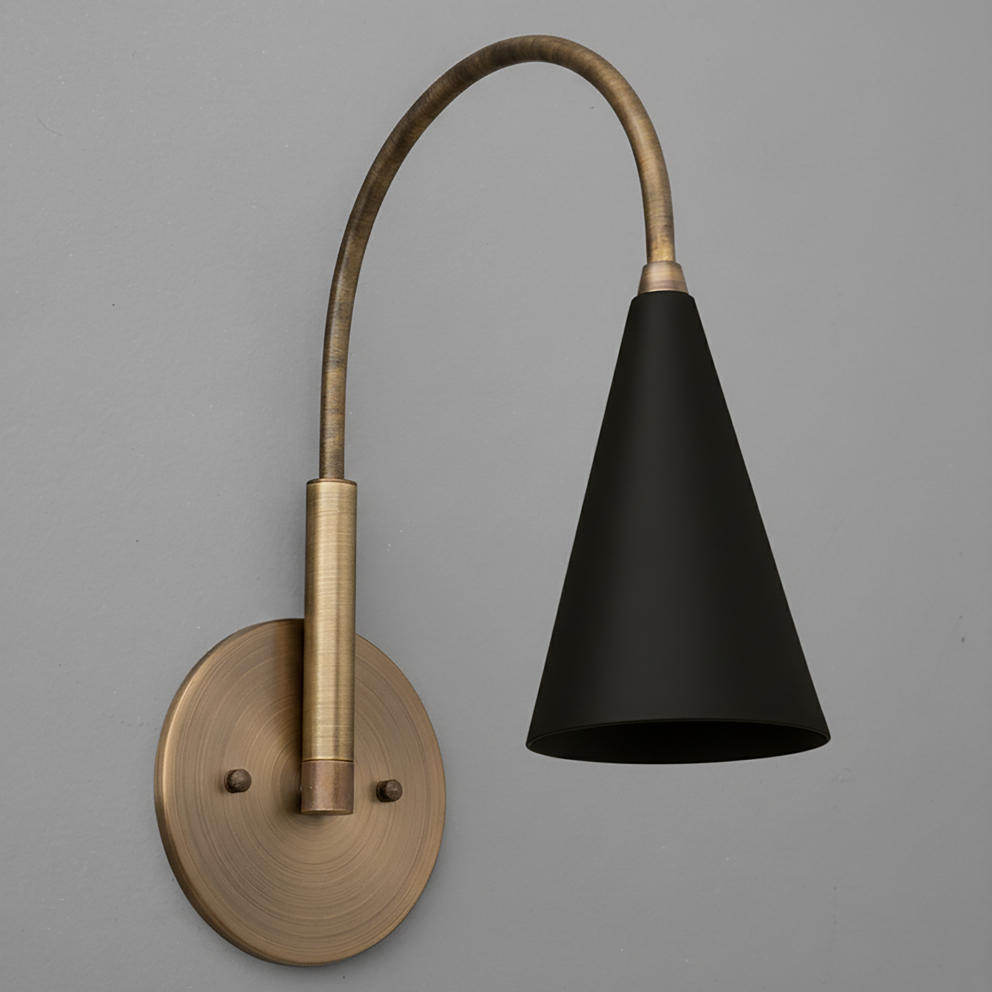 Brushed brass wall sconce with curved arm and matte black conical shade. - SCONCE MODEL NO. 1309
