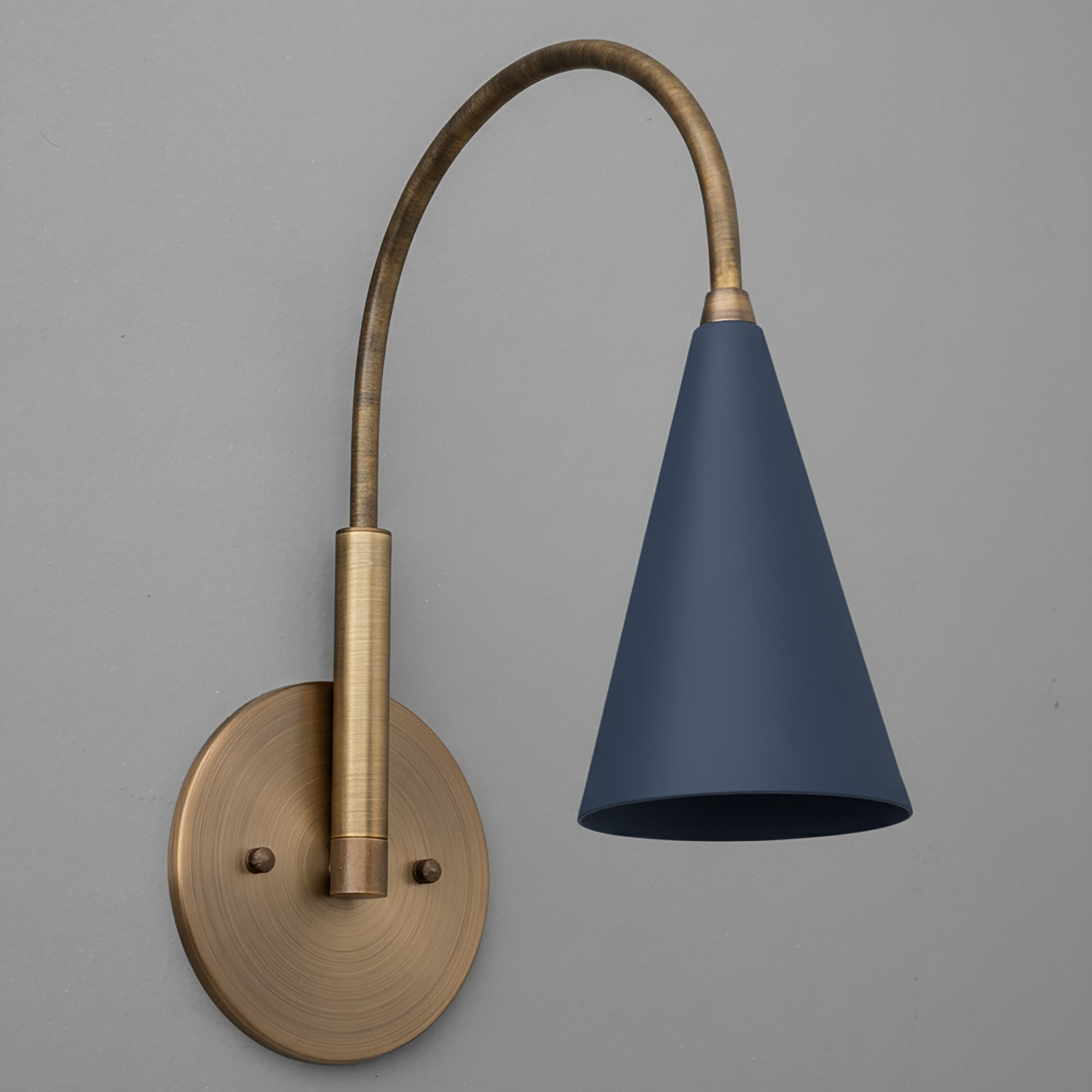 Matte navy blue conical metal shade with curved antique brass arm and round wall plate single-bulb sconce. - SCONCE MODEL NO. 1309