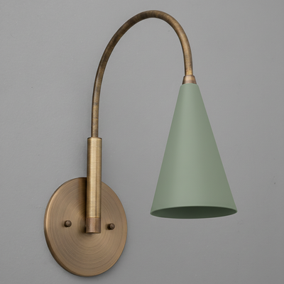 Wall-mounted sconce with brushed brass finish and curved arm holding a matte sage green conical shade. - SCONCE MODEL NO. 1309