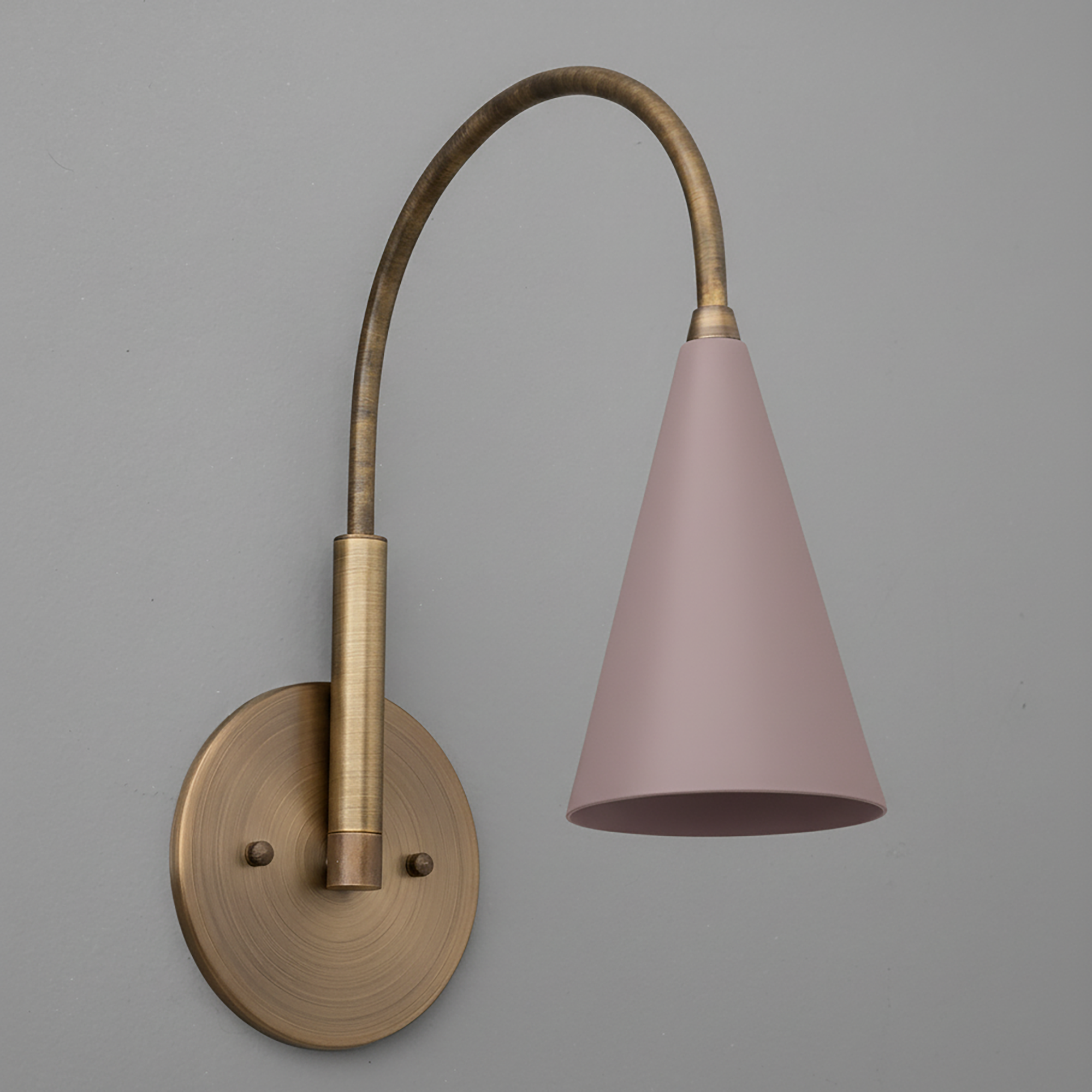 Brushed brass wall sconce with curved arm and matte mauve conical shade. - SCONCE MODEL NO. 1309