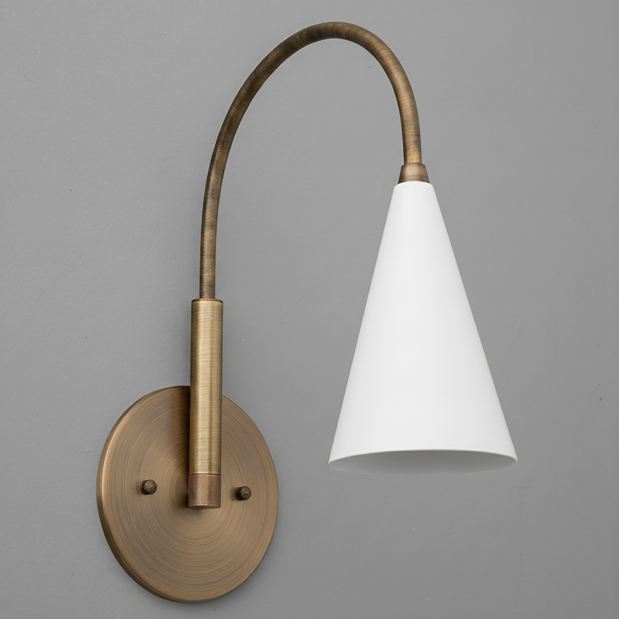 Antique brass wall sconce with curved arm and white conical glass shade. - SCONCE MODEL NO. 1309
