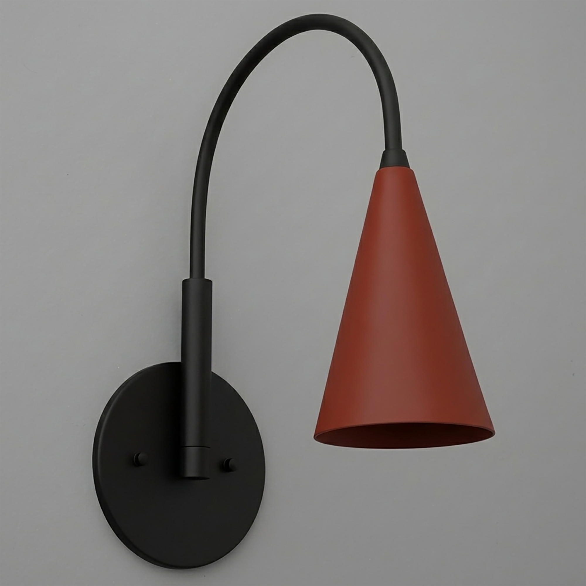 Matte black wall sconce with curved arm and rust-red conical metal shade. - SCONCE MODEL NO. 1309
