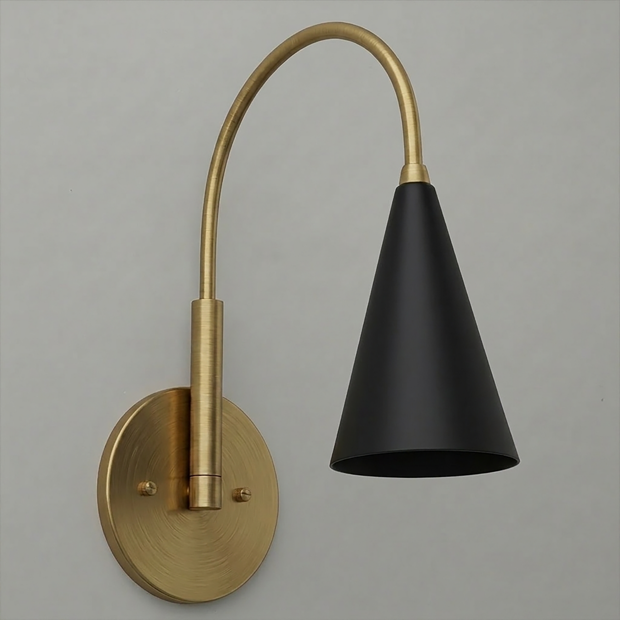 Matte black conical metal shade with a curved brass arm and round brass wall mount sconce. - SCONCE MODEL NO. 1309