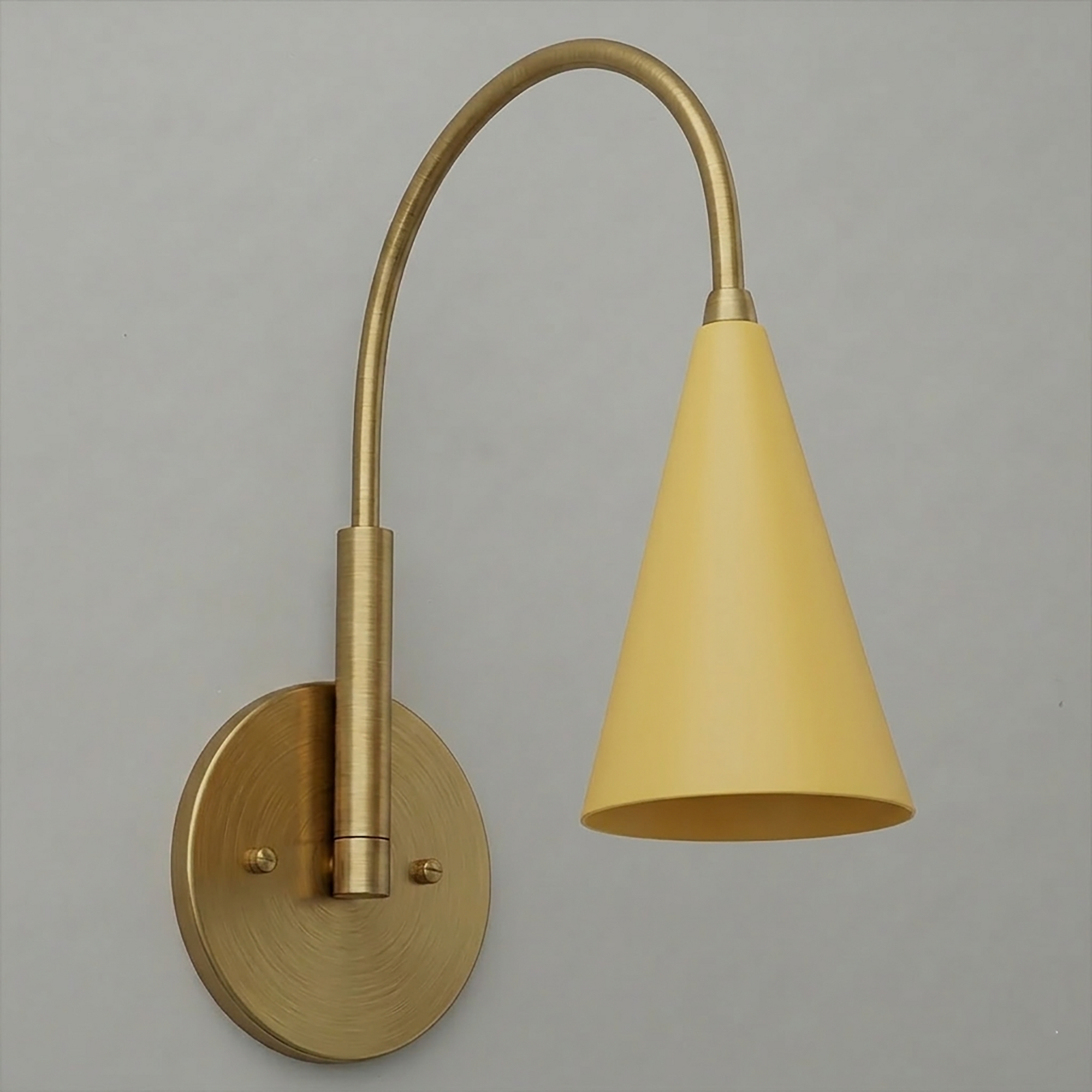 Brushed brass wall sconce with curved arm and matte yellow conical shade, single bulb design. - SCONCE MODEL NO. 1309