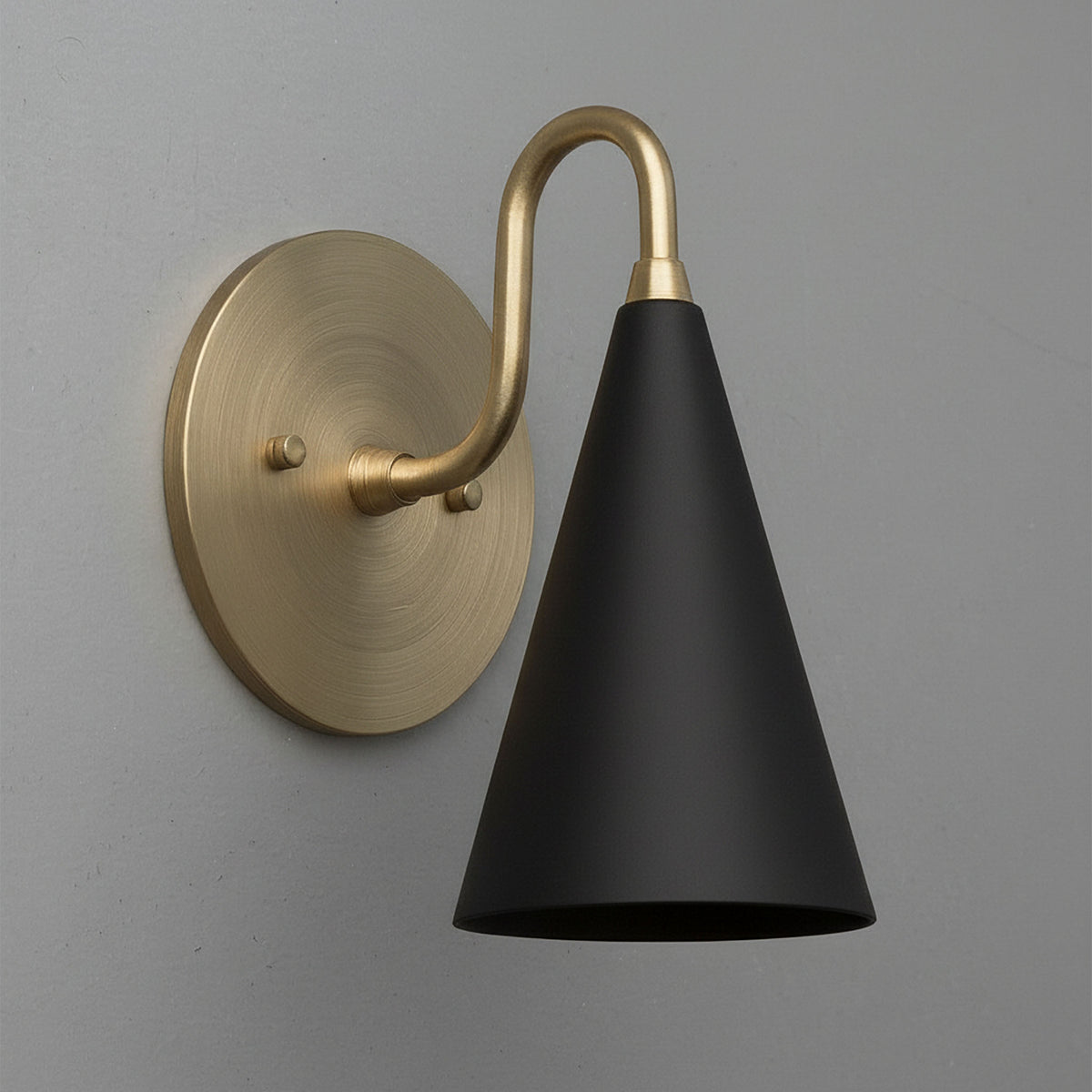 Wall sconce with matte black conical shade and antique brass curved arm and round backplate. - Sconce Model No. 2900