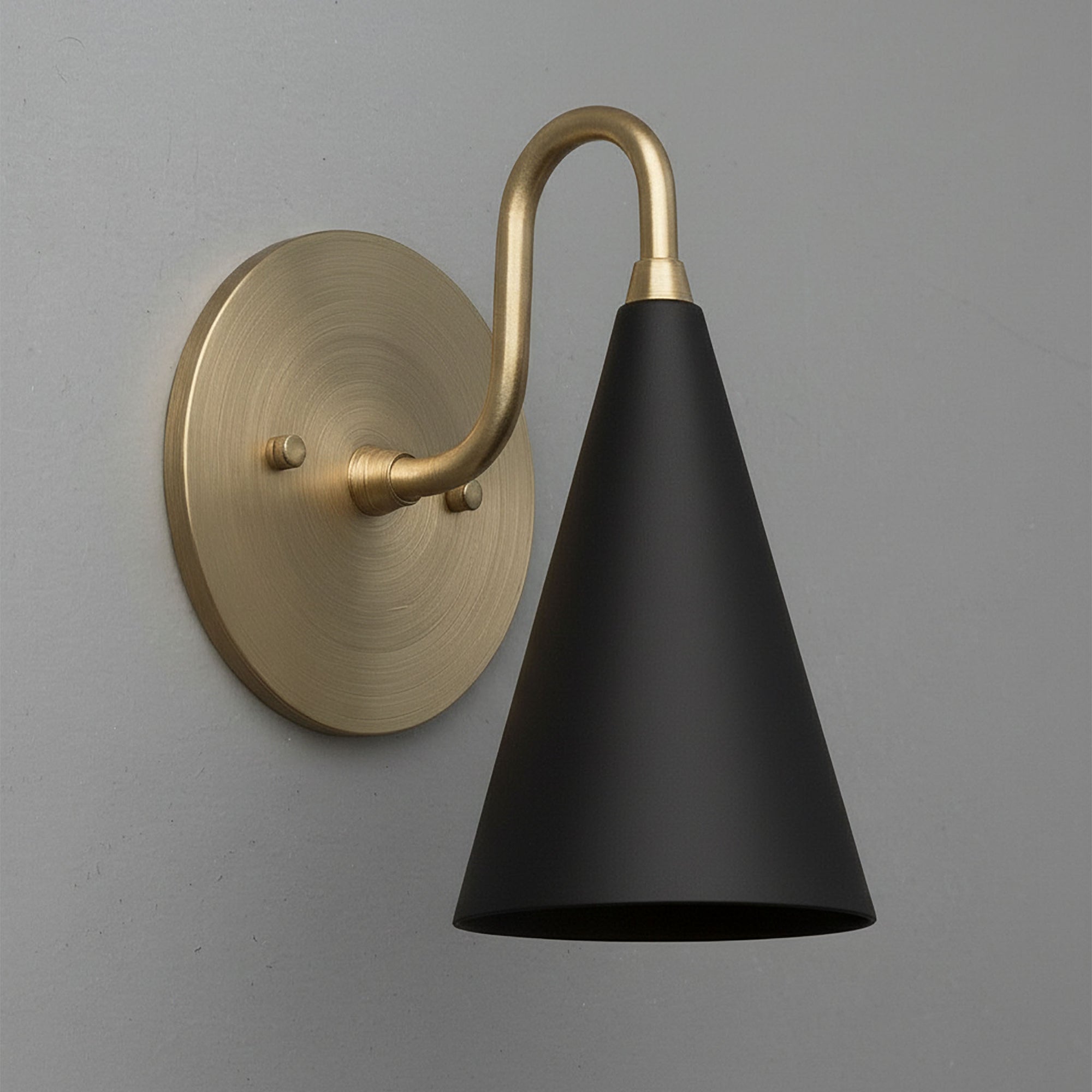 Wall sconce with matte black conical shade and antique brass curved arm and round backplate. - Sconce Model No. 2900