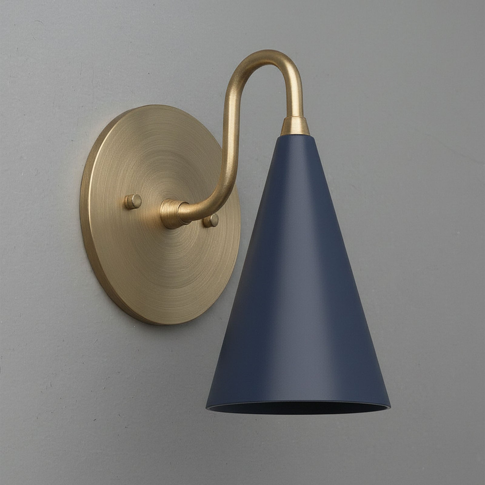 Antique brass sconce with a smooth curved arm and a matte coal blue cone-shaped shade mounted on a round wall plate. - Sconce Model No. 2900