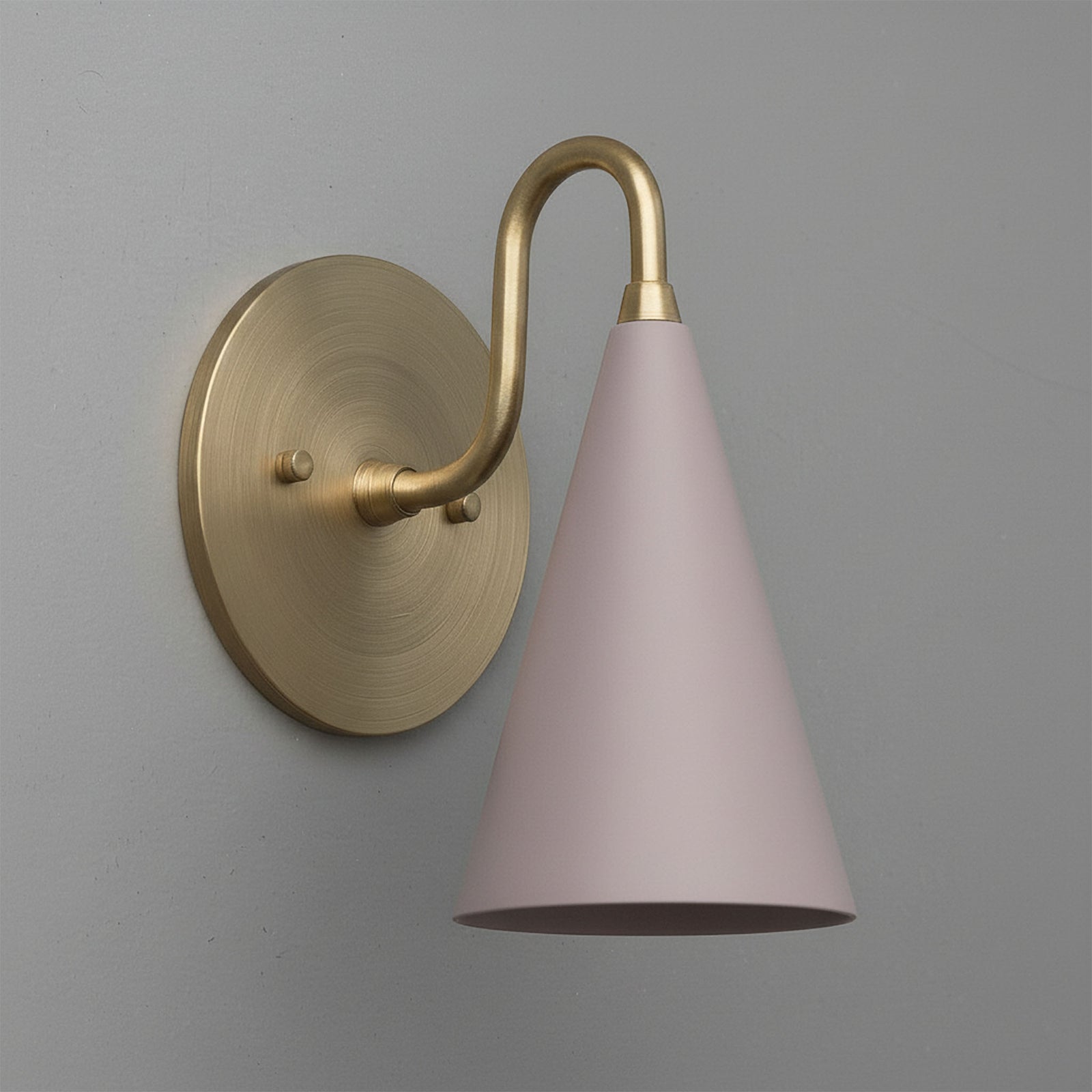 Antique brass wall sconce with mauve conical shade on gray background. - Sconce Model No. 2900