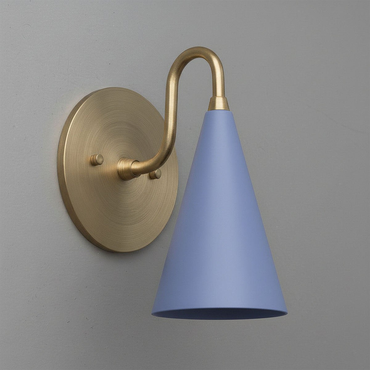 Antique brass wall sconce with sleek periwinkle blue conical shade mounted on gray wall. - Sconce Model No. 2900